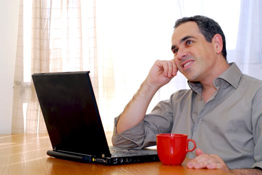 Man sitting at a desk and looking into his computer