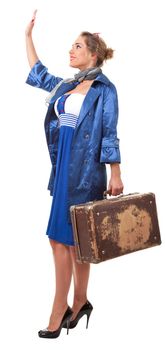 young woman dressed in retro style with an old suitcase