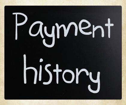 "Payment history" handwritten with white chalk on a blackboard
