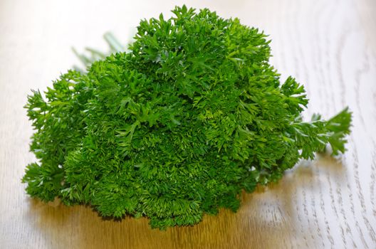 bunch of parsley, close-up on wooden table