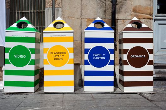 Four containers for recycling paper, metal, plastic and glass - Gijon, Asturias
