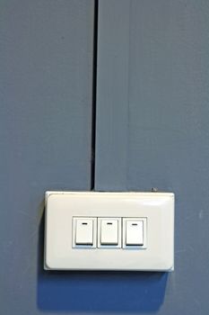 Tripple of Light Switch on gray Wall