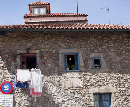 White laundry hanging to dry in a stone house