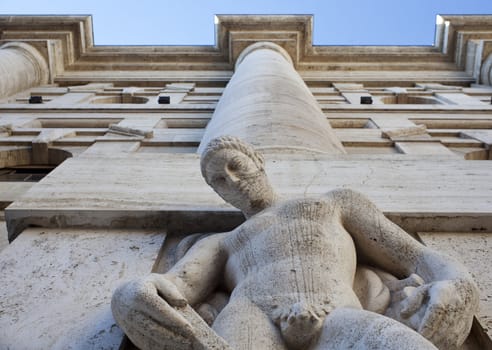 Man statue of the exchange building of Milan, Italy