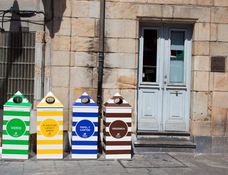 Four containers for recycling paper, metal, plastic and glass - Gijon, Asturias