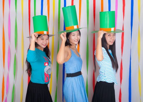 Asian-Thai girls hold big green hat on St.Patrick's Day
