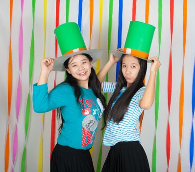 Asian Thai girls hold big green hat on St.Patrick's Day, we act in happiness and celebrating feeling