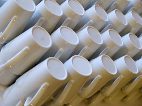 Stack of white coffee espresso cups in a restaurant cafe