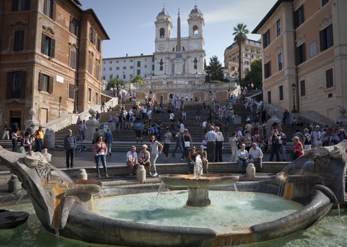 MORNING BY SPANISH STEPS, ROME, ITALY - SEPTEMBER, 26, 2011: The landmark seen from Piazza di Spagne with Trinita dei Monti church at the top. In front Fountain of the Old  Boat by Pietro Bernini.