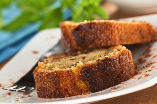 Fresh homemade slices of pound cake filled with chocolate pieces (Selective Focus, Focus on the right upper edge of the slice)