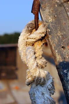 bend of old rope of the bow of the old boat (marine knot). Close up