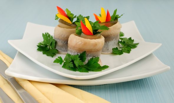 Rolls of herring fillets with pickled cucumber and pepper