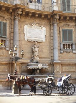Buggy in the Quattro Canti, one of the octagonal four sides of Baroque square in Palermo - Italy