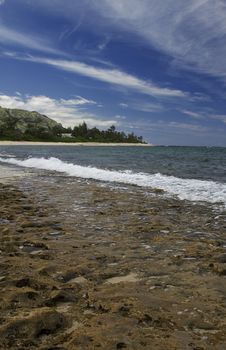 Volcanic rock beach with foaming water