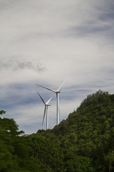 two windmills against a cloudy sky