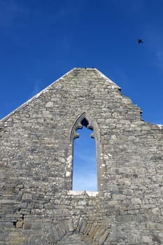 ancient old arched window in ruin walls of historic building in Ireland