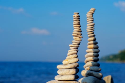 Two pile of pebbles in the balance on the seacoast