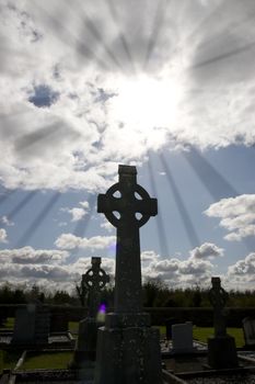 rays of light at an old ancient Celtic graveyard with unmarked gravestones in Ireland