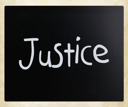 "Justice" handwritten with white chalk on a blackboard