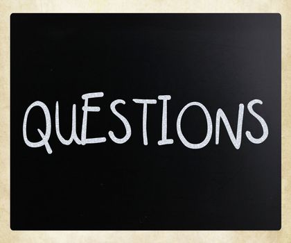 The word "Questions" handwritten with white chalk on a blackboard