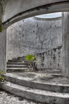 An ancient spiral staircase in an old abandoned mansion.