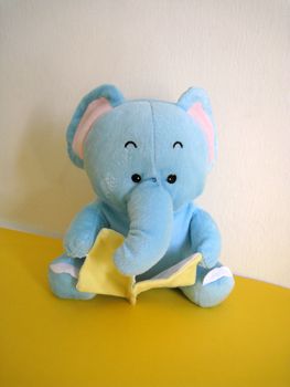 a elephant soft toy reading book