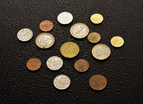 Coins on black wood background