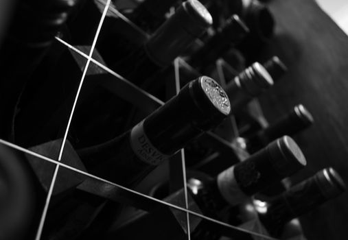 Monochrome, close upward angled view of wine rack