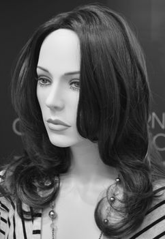 Monochrome close up of mannequins head and shoulders with long hair