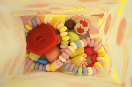 Colourful sweets mix inside paper bag
