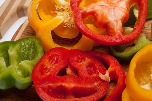 close up of red, yellow and green peppers