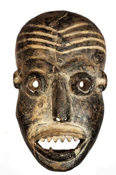 Wooden carved African tribal mask, dark wood with painted face. Isolated on white background. Congo, Africa