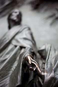 Virgin Mary touching hand of Jesus - Sculpture on the bronze portal