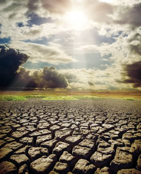 dry lake and dramatic sky with sun