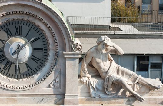 Clock and man statue, Milan