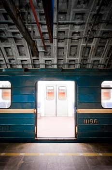 Subway train in dark tunnel with doors opened