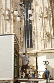 Worker next to the Milan catheedral, Italy