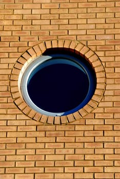 round glass window in bricks