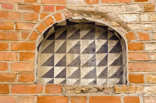 Abandoned building of red brick wall and arches background.