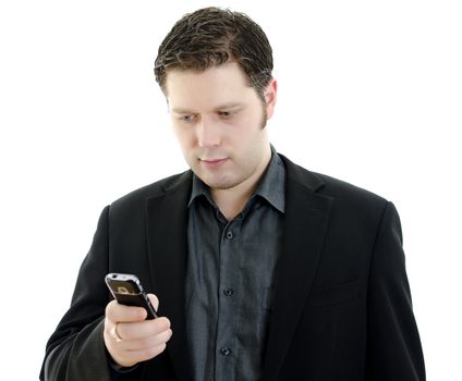 Portrait of a handsome young business man using mobile phone. Isolated on white background with copy space.