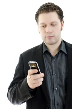 Portrait of a handsome young business man using mobile phone. Isolated on white background with copy space.