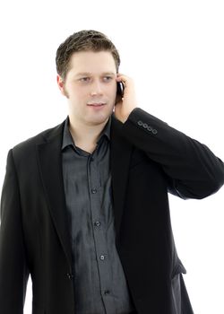 Portrait of a handsome young business man talking on mobile phone. Isolated on white background with copy space.