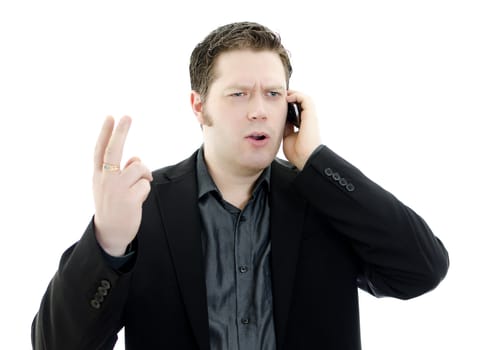 Portrait of a handsome young business man talking on mobile phone. Isolated on white background with copy space.