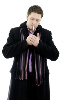 Portrait of a handsome young business man lights a cigarette. Isolated on white background with copy space.