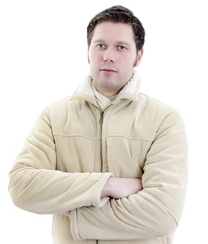 Portrait of a handsome young man in winter coat with arms crossed. Isolated on white background with copy space.