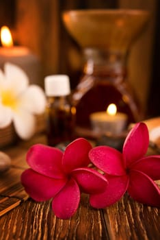 Spa treatment setting with frangipani ,pure essential oil and burning candle.