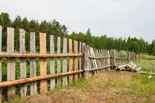 Old wooden fence repair at the countryside