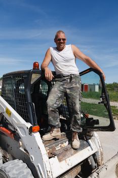 Bobcat Driver.A construction worker stands on his construction machine