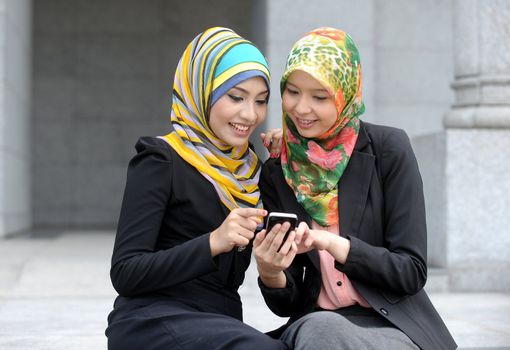 Two Scarf girl use smart phone
