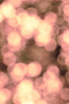 The sparkling blur abstract pale pink and yellow background.